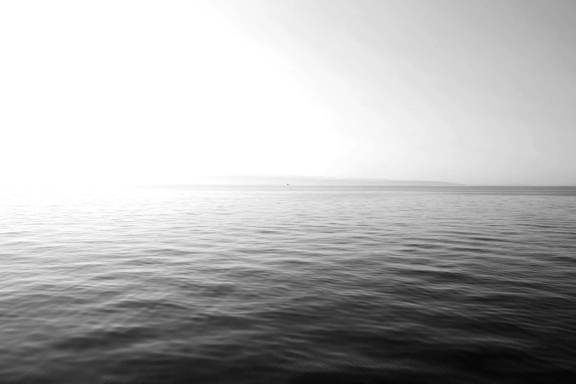 body of water under blue and white sky at daytime